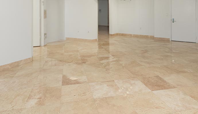 Clean and shiny travertine floor in interior space Clean and shiny travertine floor in interior space