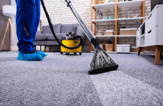 Professional worker providing carpetcleaning service with advance equipment