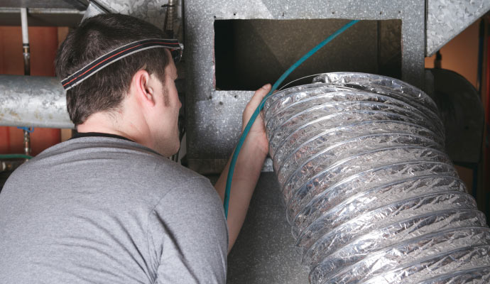 technician fixing air duct